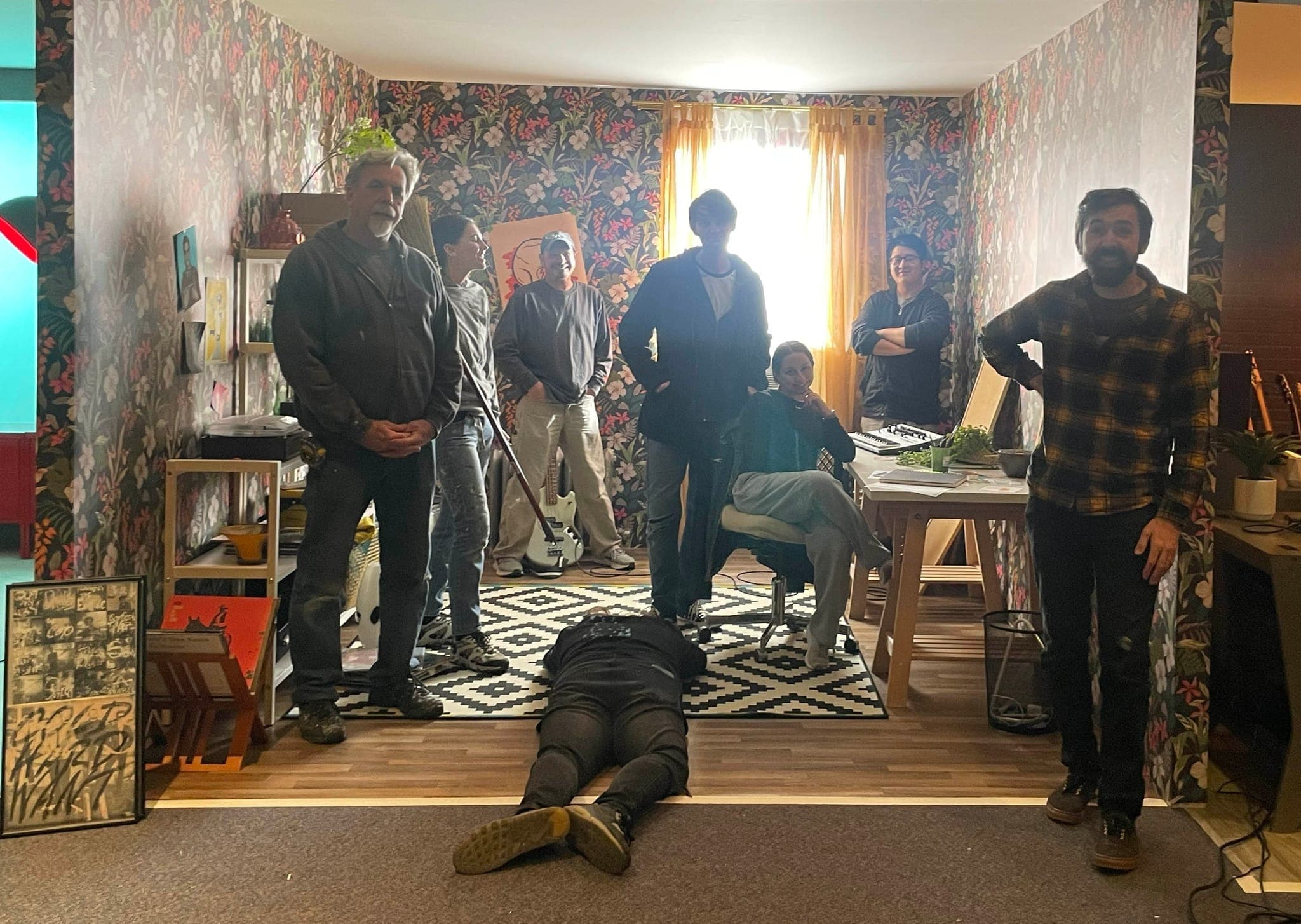The full crew gathered on a dressed set