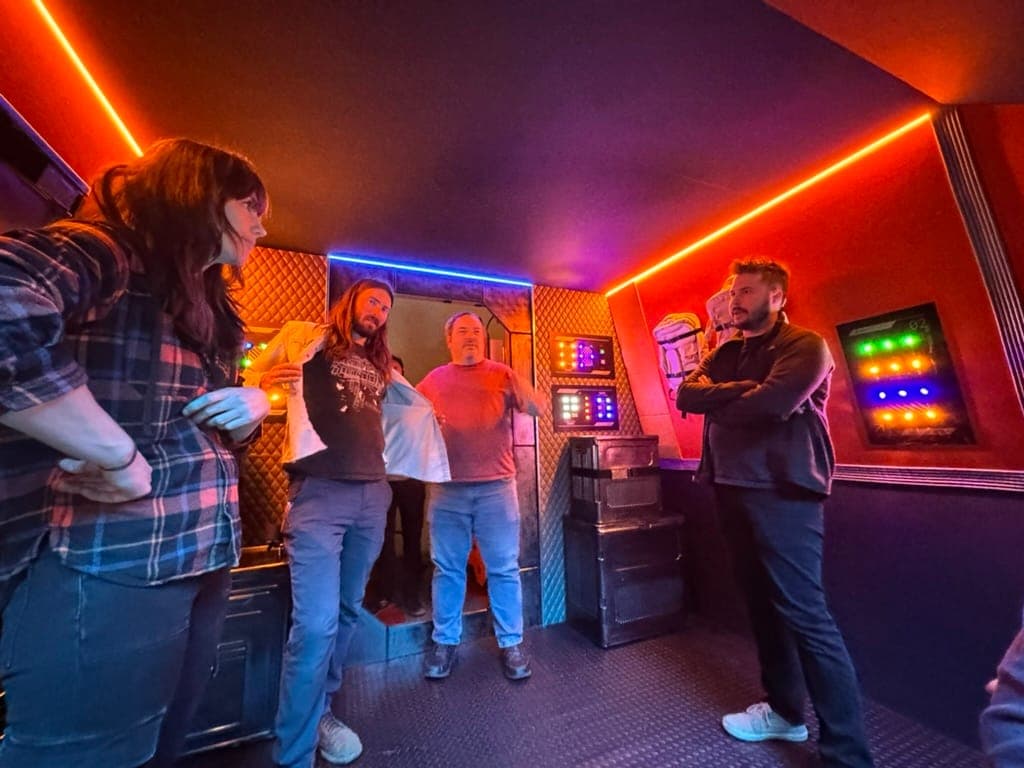The crew gathered inside the finished spaceship set between takes